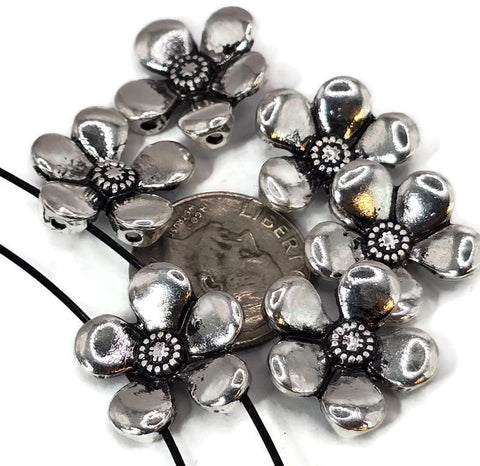 Add elegance to your creations with these silver flower slider beads. Designed in a rounded five-petal form with detailed centers and textured backs, these 2 hole beads stay stable in necklaces and bracelets. Their floral shape makes them excellent as focal beads or decorative spacers, perfect for bohemian, garden-inspired, or handmade artisan jewelry. Crafted from sturdy alloy, these beads are an essential for jewelry makers seeking unique and timeless floral components.