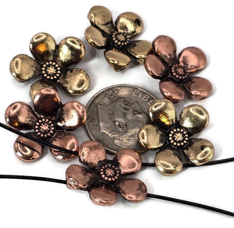 These flower 2 hole slider beads feature detailed five-petal blossoms in antique copper and rustic gold finishes. Perfect as flat-fitting focal beads for bracelets, chokers, and necklaces, their metal build is durable yet lightweight. The two-hole construction ensures balance and stability, making them ideal for multi-strand designs. With their charming floral style, these beads add elegance and nature-inspired detail to handmade boho, vintage, or garden-themed jewelry.