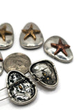 Celebrate summer style with these metal starfish beads crafted as 2 hole sliders for secure, flat-fitting jewelry designs. Each oval bead showcases a raised starfish motif in warm copper or gold set on silver-toned metal, perfect for beach jewelry, nautical necklaces, and ocean-inspired bracelets. Durable yet lightweight, they work beautifully as focal beads or decorative spacers, adding coastal symbolism of guidance and renewal to your handmade accessories.