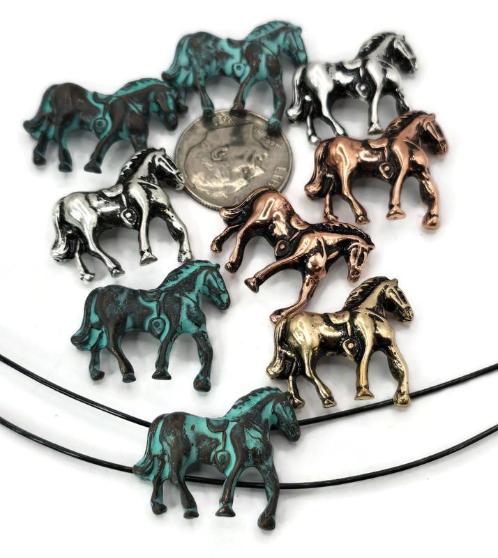 These horse-shaped 2 hole slider beads come in silver, copper, bronze, and turquoise patina finishes. Each bead captures the powerful stance of a horse, making them ideal for cowboy, Western, and equestrian jewelry projects. The two-hole construction ensures a flat and secure fit, perfect for bracelets, chokers, and necklaces. Durable yet lightweight, these beads serve as focal pieces or spacers, adding rustic charm and symbolic meaning to handmade artisan jewelry.