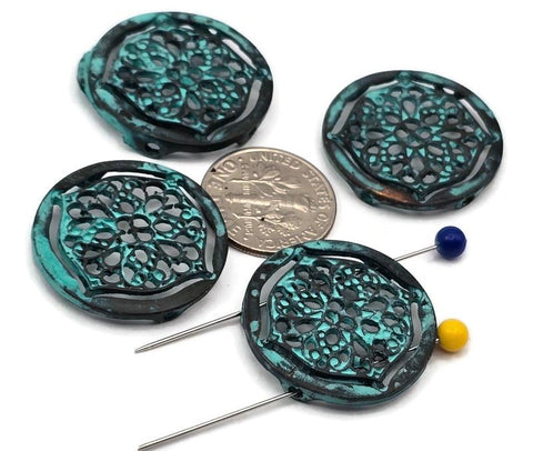 These round filigree 2‑hole slider beads feature a rich turquoise patina over dark antiqued metal, creating an aged, verdigris effect. The lace‑style cutout medallion adds airy detail without bulk. Dual holes keep the focal flat on bracelets, chokers, or pendant bars. Perfect for boho, Southwestern, and vintage designs that need color, texture, and reliable alignment.