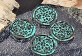Round turquoise patina 2‑hole slider beads add statement color and intricate texture to handmade jewelry. The airy filigree pattern sits inside a sculpted rim with a time‑worn verdigris finish. Two holes keep the focal flat and forward facing on bracelets, collar necklaces, or pendant bars. Perfect for boho chic, Southwestern, and vintage‑inspired designs.