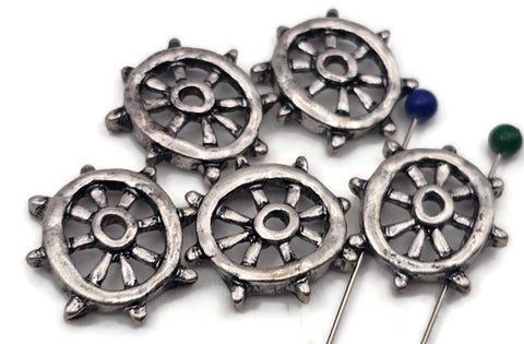 Set a steady course with these ship wheel 2 hole slider beads. Finished in antique silver, each open‑spoke helm is cast in durable, non‑tarnish metal. Dual holes keep the focal flat and secure on leather, cord, or chain—perfect for bracelets, chokers, pendants, earrings, and rings. Mixed‑metal friendly and lightweight for everyday wear. Package includes 5 matching nautical sliders.
