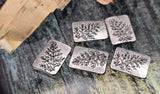 Botanical silver rectangle 2‑hole beads for fine stringing. The etched foliage design offers artisan charm without bulk. Small, parallel holes are perfect for 0.015–0.018&quot; beading wire, FireLine, or nylon thread; not for leather/chain. Use as center focals or neat spacers in layered, delicate projects. Non‑tarnish metal. Set includes 5 matching sliders.