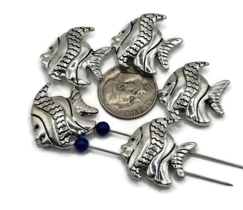 Dive into beach-inspired jewelry with these fish 2-hole slider beads. Crafted in antique silver, each bead features detailed fins and wavy etchings that bring ocean life to your designs. The dual-hole design makes them perfect for multi-strand bracelets, chokers, or necklaces. Great for nautical, boho, or seaside accessories, these beads are a must-have for ocean lovers and artisan jewelry makers.