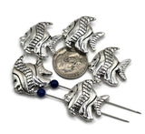 These antique silver fish slider beads are perfect for creating coastal and nautical jewelry. With textured details on the fins and body, they capture the charm of the sea. The 2-hole slider construction keeps strands aligned, making them ideal for structured bracelets, layered chokers, and ocean-themed necklaces. Great for boho jewelry, summer accessories, or ocean-inspired artisan designs for beach lovers.