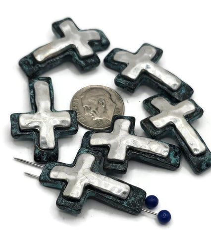 These rustic cross slider beads are perfect for meaningful jewelry designs. Each 2-hole bead features a raised silver-tone cross framed by a dark patina border, creating a bold artisan look. The dual-hole design keeps them flat and aligned, making them ideal for bracelets, chokers, or multi-strand necklaces. Great for spiritual, boho, or Western-themed jewelry collections that celebrate faith and individuality.