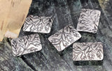 Cottagecore rectangle leaf beads with two small holes for fine stringing. Antique silver plating, raised botanical branches, softly rounded edges. Perfect for delicate bracelets, stacking necklaces, and dainty earrings. Not compatible with leather or chain. Durable, non‑tarnish finish. Pack of five 2‑hole nature sliders.