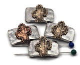 Add Western character to your designs with cactus two‑hole slider beads. Dual holes on each side keep double‑strand bracelets and necklaces aligned, or use a single set for flexible layouts. The textured metal rectangle and cactus focal pair beautifully with leather, cord, gemstones, and glass. Great for earrings, rings, zipper pulls, and décor accents. Hard to find in stores—curated for makers who love unique components.