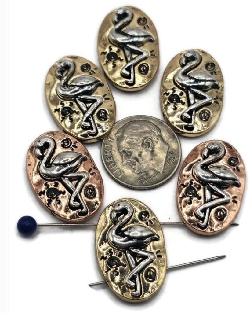 These flamingo 2-hole slider beads bring tropical charm to your handmade jewelry. Each oval bead features a raised flamingo motif set against an antique silver finish with copper and bronze highlights. Their dual-hole slider design ensures strength and balance, making them perfect for chokers, bracelets, and necklaces. Ideal for boho festival jewelry, summer collections, or coastal-inspired handmade gifts.
