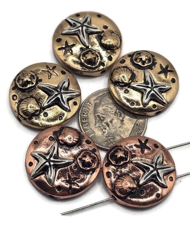 These starfish and seashell slider beads are perfect for coastal-inspired designs. Each round bead features raised starfish and shell motifs in antique silver with bronze and copper accents. The 2-hole slider construction ensures cords stay flat and secure, making them ideal for bracelets, chokers, and necklaces. Excellent for beach jewelry, boho creations, or artisan gifts for ocean lovers.