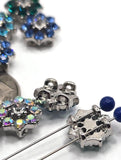 Bring color and brilliance to your jewelry with these rhinestone flower slider beads. Available in bold aqua, deep blue, emerald green, and sparkling AB crystal, each bead features a flower shape with rhinestone petals surrounding a bright center stone. Their dual-hole slider design ensures stability and flat alignment for bracelets, chokers, and necklaces. Perfect for bohemian jewelry, statement festival pieces, or sparkling handmade gifts.