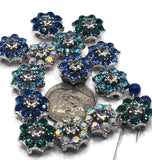 These rhinestone flower slider beads bring stunning sparkle to handmade jewelry. Designed in vibrant shades of aqua, blue, green, and iridescent AB crystal, each bead features shimmering petals and a clear rhinestone centerpiece. Their silver-tone base and dual-hole slider design ensure secure, balanced strands for chokers, bracelets, and artisan necklaces. Perfect for dazzling festival jewelry, statement boho pieces, or elegant handmade gifts.