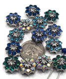 Add radiant shimmer to your jewelry with these rhinestone flower 2-hole slider beads. Featuring vibrant blue, green, aqua, and AB finishes, each bead sparkles with a clear rhinestone center and crystal-encrusted petals. The dual-hole slider design ensures cords remain flat and secure, perfect for chokers, wide bracelets, and multi-strand necklaces. Excellent for boho jewelry, glamorous accessories, or handmade gifts with sparkle.