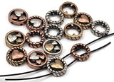 Mixed‑metal heart 2 hole slider beads that instantly become focal beads in artisan jewelry. Each round metal bead features a rope‑edge frame with raised hearts for rich dimension. Unique beads and premium metal findings that photograph beautifully for Etsy and eBay. Lead‑ and nickel‑free with a durable, anti‑tarnish finish. Assorted silver, gold, and copper tones add warm contrast to bracelets, chokers, and pendant designs.