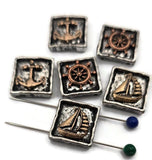 Bring seaside charm to your collection with these nautical sliders. The sculpted sailboat, wheel, and anchor sit inside rustic square frames with hand‑worn edges. Mixed silver and bronze tones highlight the relief work and create a classic maritime feel. Excellent as focal beads in bracelets or as pendant accents on necklaces. Subtle finish variations give every package an artisan touch.