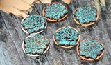 Elevate your designs with these boho lotus sliders. The detailed floral pattern is highlighted by a weathered turquoise patina, set in a round metal frame. Two-hole construction ensures a tidy, centered look in finished pieces. Use as a standout focal for bracelets or as a pendant accent on necklaces. Mixed-metal settings—silver, copper, brass—offer versatile styling for artisan jewelry.