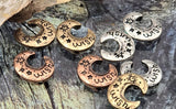These moon-themed 2 hole slider beads bring a whimsical touch to artisan designs. The curved crescent features stamped “wish” lettering with star and sparkle motifs. Purposeful antiquing settles into the details, creating depth that photographs beautifully. Use as focal beads in bracelets or as simple pendants on necklaces. Available in antique silver, copper, and brass tones.