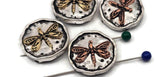 Mixed‑metal dragonfly 2 hole slider beads featuring a sculpted dragonfly with pierced wing detail. Distressed silver coins highlight warm copper and golden brass. Use as focal beads for bracelets or pendant centers on necklaces. SEO phrases: dragonfly focal bead, nature jewelry supplies, garden bead, metal slider, artisan beads for bracelets.