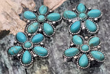 Southwestern turquoise flower beads crafted as 2 hole sliders. The antique silver setting features tiny beaded edging and six teardrop cabochons circling a round center. Bold color, dimensional texture, and easy face‑forward fit make a reliable focal bead for bracelet designs and pendant centers on necklaces. Boho cowgirl aesthetic with classic concho‑floral energy.