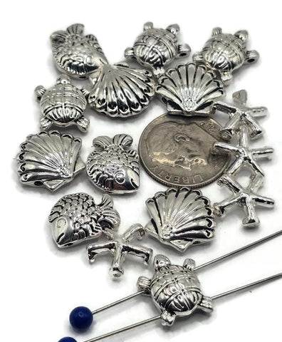 These ocean slider beads bring coastal magic to handmade jewelry. Featuring sea turtles, fish, seashells, and starfish in antique silver, their detailed raised designs add charm to necklaces, chokers, and bracelets. With 2-hole slider construction, strands remain flat, secure, and balanced. Perfect for boho designs, nautical jewelry, or unique handmade gifts inspired by the sea.