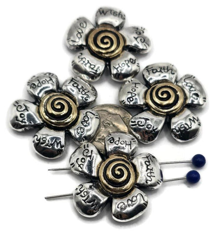 These large flower slider beads make a bold statement in handmade jewelry. Each antique silver bead features bronze-gold spiral centers and engraved petals with meaningful words such as Love, Faith, Hope, Joy, and Wish. With a secure 2-hole slider construction, they align cords perfectly, making them excellent for chokers, necklaces, or bracelets. Perfect for boho designers or spiritual artisan jewelry collections.