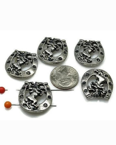 These Western slider beads feature a powerful rearing horse inside a detailed horseshoe design. Crafted in antique silver, these beads bring rustic cowboy charm to chokers, bracelets, and necklaces. With 2-hole slider construction, strands stay flat and secure. Perfect for rodeo jewelry, cowboy festival fashion, or handmade gifts for horse lovers, ranchers, and equestrian-inspired collections.