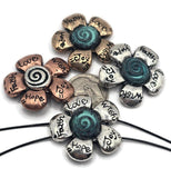 Brighten your jewelry designs with these inspirational two-hole flower slider beads. Each bead features engraved words like Faith, Hope, Love, and Joy, reminding wearers of positivity and strength. With two parallel holes, these sliders are perfect for creating stable, flat designs in bracelets, chokers, or multi-strand projects. Available in mixed metal tones, they bring texture and meaning to handmade crafts and artisan jewelry pieces.