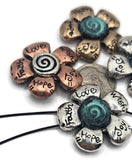 Add symbolic beauty to your creations with these two-hole floral slider beads. Crafted in silver and copper tones with turquoise accents, each bead displays encouraging words: Faith, Joy, Love, and Hope. The dual-hole design provides stability for bracelets or necklaces, making them ideal for jewelry makers and DIY crafters who want to blend function with meaningful design. A versatile and heartfelt supply choice.