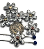 Add floral beauty to your creations with these silver-tone daisy slider beads. Each six-petal flower is enhanced with a spiral center in copper or gold, giving every piece a custom artisan feel. With holes designed for threading fine cords or wire, they’re ideal for handmade bracelets, necklaces, and unique wearable art. Perfect for Etsy sellers or DIY hobbyists seeking standout floral jewelry components.