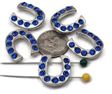 Sparkling horseshoe 2 hole slider beads with vivid sapphire blue crystals in shiny silver metal. Western cowgirl focal beads for lucky bracelets and chokers. Dual, small parallel holes fit fine beading wire, FireLine, or micro cord (not leather). Lightweight, tarnish‑resistant finish. Set of 5 rhinestone horseshoe beads for rodeo, barrel‑racing, and country wedding jewelry.