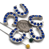 Shine bright with sapphire rhinestone horseshoe beads. Silver metal, 2‑hole slider style for flat, balanced placement on fine beading wire or braided thread. Not for leather. Use in rodeo jewelry, lucky charm bracelets, and prom or game‑day accessories. Tarnish‑resistant finish. Five Western focal beads included.
