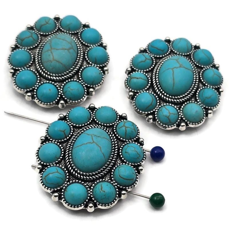 Large turquoise concho 2 hole slider beads with oval center cabochon and halo of round faux turquoise set in antique silver. True slide double‑strand design with small parallel holes for fine beading wire, FireLine, or micro cord (not leather/chain). Bold round focal beads for bracelets and chokers. Jewelry making supplies, components parts, unique spacer/filler DIY. Set of 3 statement sliders.
