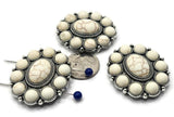 Create bold statement pieces with these ornate oval slider beads. Featuring a faux white howlite cabochon center framed by smaller cabochons in antique silver settings, these two hole connectors are designed for stability and style. Perfect as bracelet or choker focals, they add an artisan, vintage-inspired aesthetic to handmade jewelry. Ideal for boho, Southwestern, or Western-style designs.