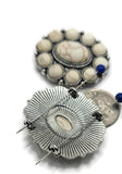 Transform your handmade jewelry with these ornate two hole slider beads. An oval faux howlite cabochon sits at the center, surrounded by a ring of smaller cabochons in antique silver settings. These dual-hole beads stay firmly aligned, ideal for double-strand bracelets, necklaces, and chokers. Their vintage-inspired look makes them perfect for boho, rustic, or Western-style artisan designs.