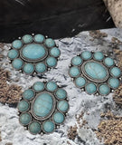 Accent your handmade jewelry with these turquoise stone oval slider beads. The textured silver settings feature a large central cabochon surrounded by smaller ones, creating bold symmetry and artisan depth. Designed with two parallel holes, these beads are perfect for multi-strand projects, ensuring stable placement in bracelets, chokers, and necklaces. A gorgeous focal option for rustic or boho jewelry makers.