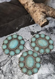 Create stunning jewelry with these turquoise oval cabochon slider beads. The ornate silver-tone frame holds a large faux turquoise centerpiece bordered by smaller matching cabochons for striking impact. With two side holes, these sliders add structure and stability to double-strand projects, making them perfect focal beads for chokers, bracelets, and artisan statement necklaces. Ideal for bohemian and Southwestern styles.