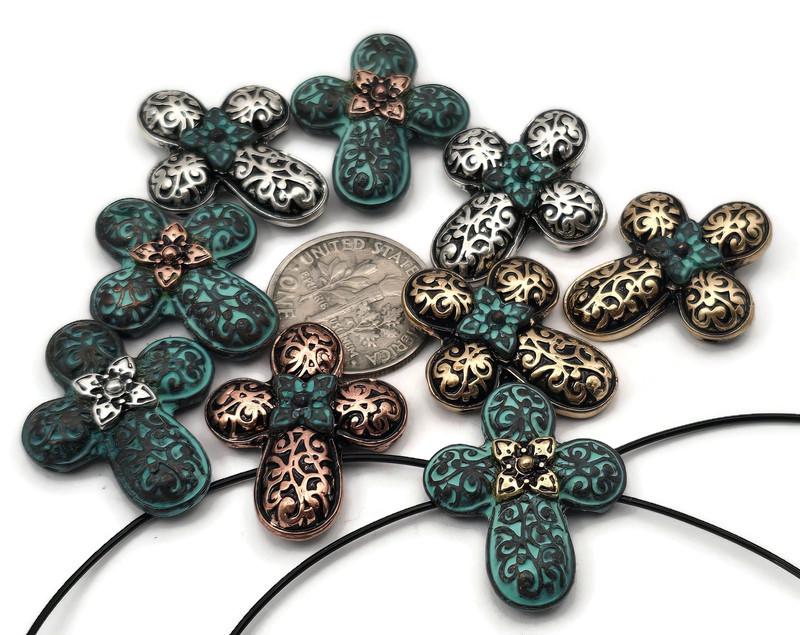 Ornate quatrefoil 2‑hole slider beads with embossed scrollwork and tiny flower centers. Mixed finishes: antique bronze, copper, silver, and verdigris patina teal. Double‑strand slide design; two small parallel holes fit fine beading wire, FireLine, or micro cord (not leather/chain). Elegant focal beads for bracelets, chokers, and rosary‑inspired necklaces. Great components for boho, gothic, and vintage jewelry making.