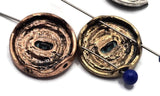 Ornate round sliders with teal center blossoms. Antique copper, silver, and gold finishes highlight the geometric engraving. Two parallel holes fit fine wire or braided thread for professional results. Pair with turquoise howlite, jasper, or crystal bicones to create eye‑catching bracelet stacks and yoga‑inspired necklaces.