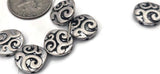 These coin‑style 2‑hole sliders bring elegant movement to your pieces. Use one as a centerpiece on a double‑strand bracelet or line up several for a pendant bar across a choker. The swirl pattern suggests Celtic waves and vintage filigree, perfect for bohemian, gothic, or minimalist stacks.