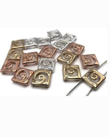 Mixed-metal spiral 2 hole slider beads in silver, gold, and rose copper. Small square pillow beads with raised swirl motif. True slide double‑strand components; small parallel holes fit fine beading wire, FireLine, or micro cord (not leather/chain). Use as focal beads or unique spacer/filler in bracelets, chokers, and necklaces. Jewelry making supplies, components parts, bulk wholesale metal, cheap sliderbeads.