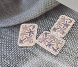 Bring ocean elegance to your jewelry with these rectangular two‑hole slider beads. Each bead features a cream and navy starfish coral pattern framed in silver, creating a coastal artisan look. Dual holes provide stability, making them perfect as focal connectors in bracelets, chokers, or layered necklaces. Ideal for nautical, beach, or summer‑inspired handmade jewelry projects with timeless seaside charm.