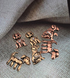 These dog shape beads bring joyful character to handmade jewelry. Featuring playful detailing such as bones and hearts, they come in antique copper and brass finishes. Their lightweight structure and simple holes make them easy to string into bracelets, necklaces, or earrings. Perfect for artisan jewelry supplies, pet adoption gifts, or keepsakes honoring beloved dogs and furry companions.