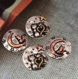 Create unique artisan jewelry with these cat moon beads. Each round bead displays a cat perched on a crescent moon or nestled in stars, accented with bronze, copper, and silver finishes. Perfect for celestial‑inspired jewelry, their size makes them ideal focal beads for bracelets, necklaces, or pendants. Great for handmade gifts celebrating cats, night skies, and mystical themes.