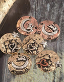 Create magical jewelry with these round cat and moon slider beads. Each bead shows delightful designs of a cat on a crescent moon or paired cats under stars, accented with heart details. Crafted in antique brass, silver, and copper finishes, they’re perfect as focals in bracelets or necklace pendants. Lightweight and artisan‑styled, they’re ideal for celestial, boho, and pet‑themed jewelry.