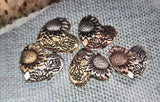 Sunflower-inspired heart beads bring both beauty and symbolism to your handmade jewelry. Each 2‑hole slider bead combines sunflower detail with floral embossing across antique brass, silver, and copper non‑tarnish finishes. Lightweight, strong, and eye-catching, they serve perfectly as pendants or focal beads in artisan necklaces and bracelets. Ideal components for boho, rustic, or nature-inspired handmade jewelry collections.