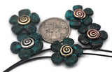 Patina flower 2‑hole slider beads with metallic spiral centers bring organic texture and color to double‑strand bracelets and chokers. The teal verdigris wash contrasts beautifully with antique silver and copper tones, enhancing natural, rustic designs. Lightweight yet durable, these beads serve as focal connectors, spacer bars, or filler beads in artisan, garden, or cottagecore jewelry collections.