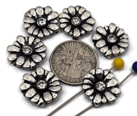 These daisy 2‑hole slider beads feature raised petals surrounding a clear crystal center for a touch of shimmer. The antique silver finish adds depth and vintage charm to bracelets, chokers, and multi‑strand designs. Ideal as focal connectors, double‑strand spacers, or accent beads, they bring refined floral style to bohemian, feminine, and artisan jewelry creations.