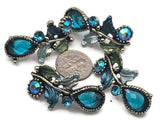 Create statement jewelry with teal crystal 2‑hole slider beads. Each ornate focal combines pear‑cut and round rhinestones with enamel leaves and dotted bezels on antique brass. The two‑hole design keeps pieces centered in multi‑strand bracelets or chokers. Perfect for bridal party gifts, prom accessories, evening jewelry, and vintage‑inspired collections.
