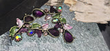 These floral vine slider beads glow with deep amethyst resin centers and iridescent rhinestones. Antique metal bezels and painted leaves provide vintage charm. The 2‑hole layout holds the component steady on multi‑strand bracelets or pendant bars. Perfect for mermaid, cottage garden, or Art Nouveau jewelry collections.